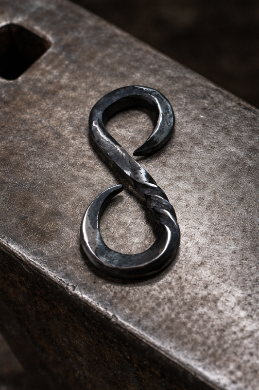 Hand-forged S-hook keychain made during beginner blacksmithing taster session at Oldboy Metal Co. in Toronto, shown on anvil.